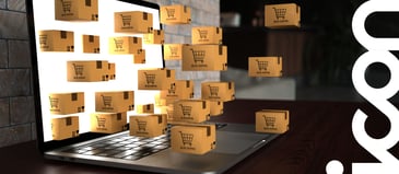 An open laptop with several floating boxes with shopping cart logos, floating out of the white screen.